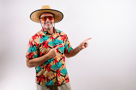 Happy traveler pointing sideways on white background