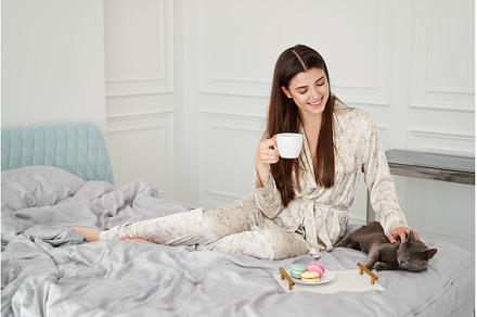 Woman having breakfast with her cat