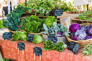 Fresh vegetable display at the market containing business, food, and basket