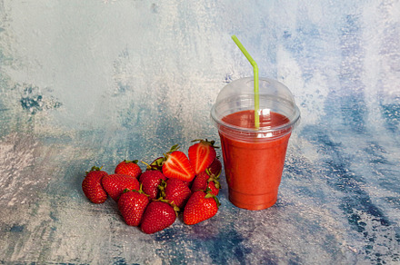 Ripe red strawberries on a blue background, a Food & Drink Photo by Photostock
