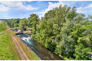 Small canal along the Rhine in Bas-Rhin, France, an Architecture Photo by Leonid Andronov