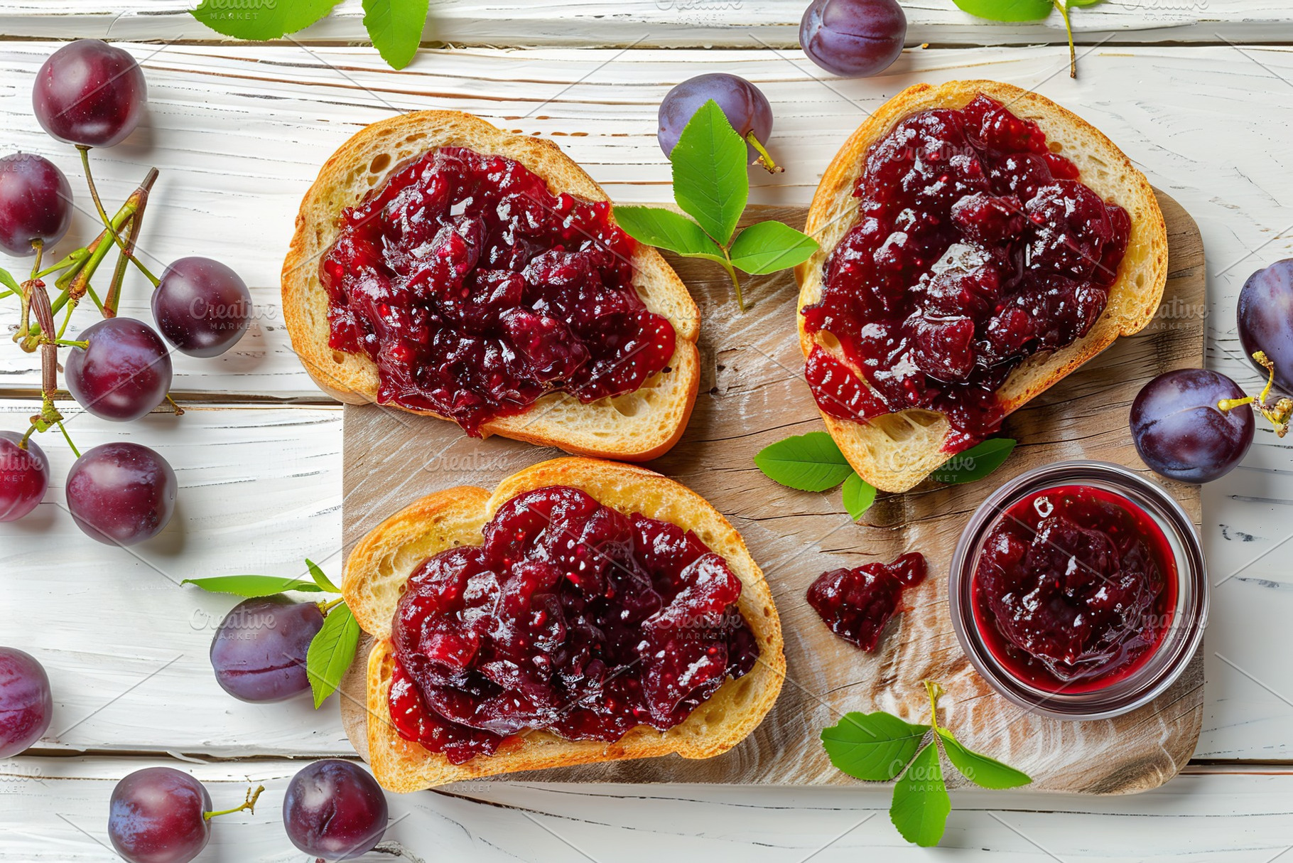 Toast breads with sweet plum jam on white wooden table, a Food & Drink Photo by AlyaAnd