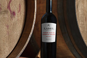 Wine Bottle on a Barrel Label Mockup, a Packaging Mockup by Hidden Hallow (Thumbnail 1 of 2)