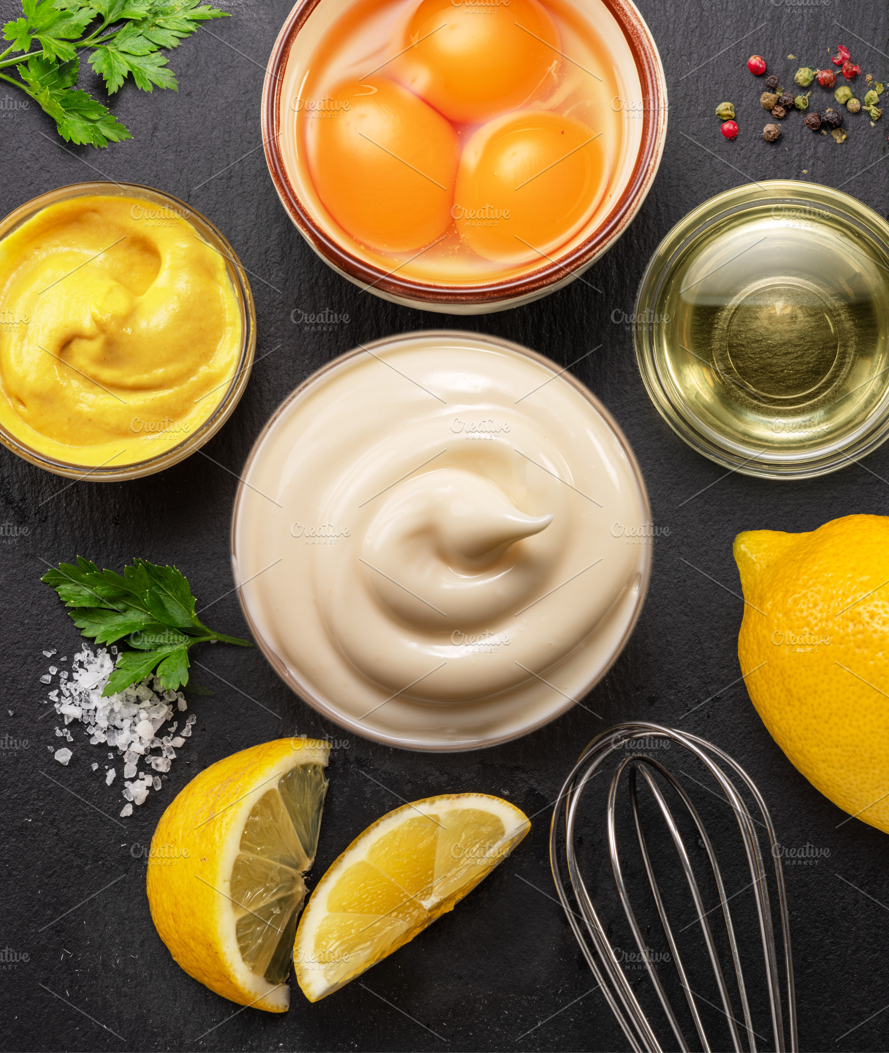 Homemade mayonnaise and mayo ingredients on black stone slate se, a Food & Drink Photo by Volff