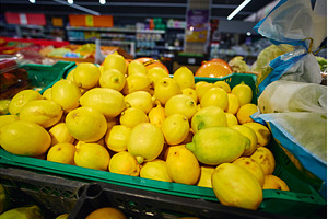 Lemons are piled high in a green, a Food & Drink Photo by darksoul72