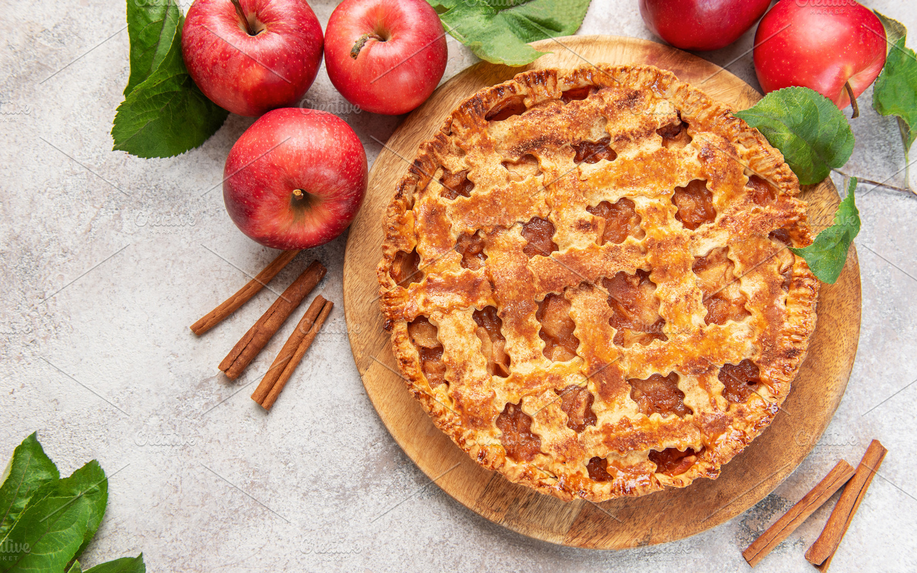 Delicious homemade apple pie decorated with fresh apples and cin, a Food & Drink Photo by Olena Rudo