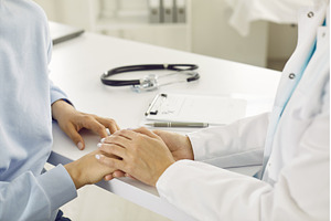Doctor comforting young woman, a Health & Medical Photo by StudioRomantic