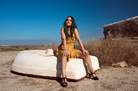 a girl sitting on a boat stranded in a summer landscape, a Beauty & Fashion Photo by YossSabalet