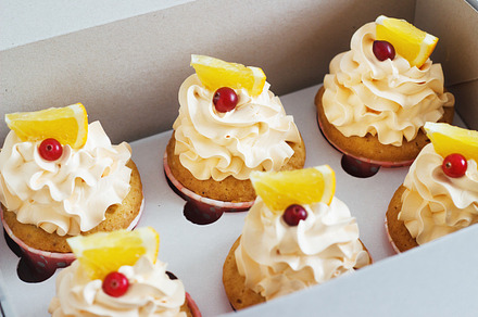 Vanilla cupcakes containing cake, food, and cream