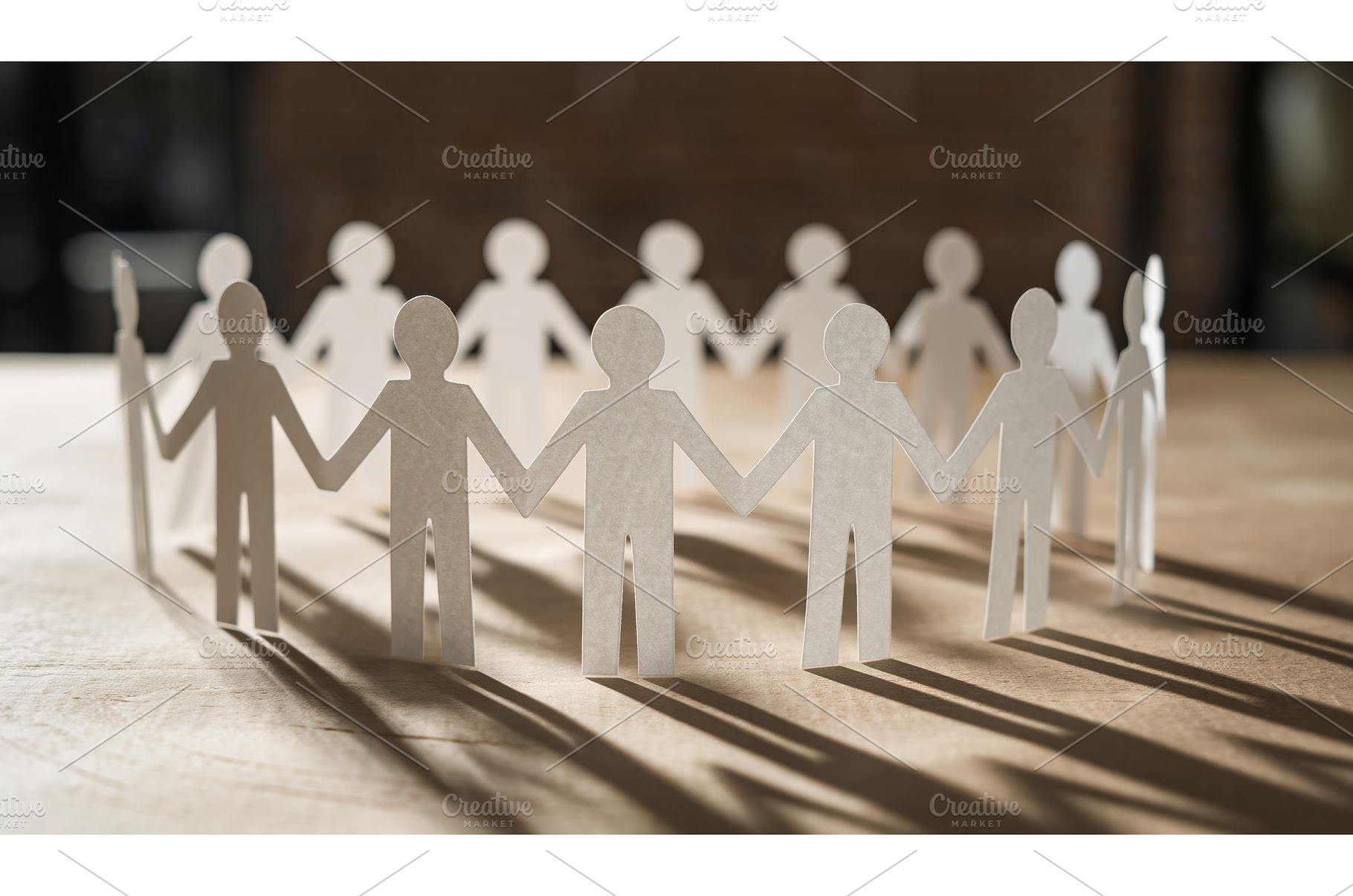 Ring of cutout white paper doll, a Person Photo by Igor Tichonow