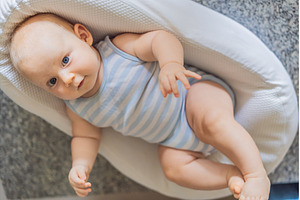 Baby lying in cozy portable lounger