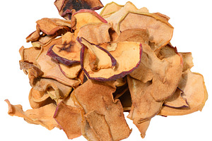 A heap of thin, crispy dried apple slices with varying shades of, a Photo by ndanko
