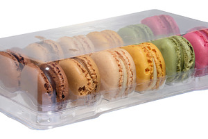 Set of colorful macaroons in transparent plastic packaging, isol, a Food & Drink Photo by ndanko