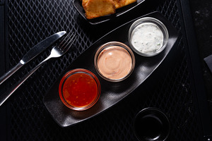 Assorted Sauces in Black Tray on Dark Table, Top View, a Photo by MDBildes