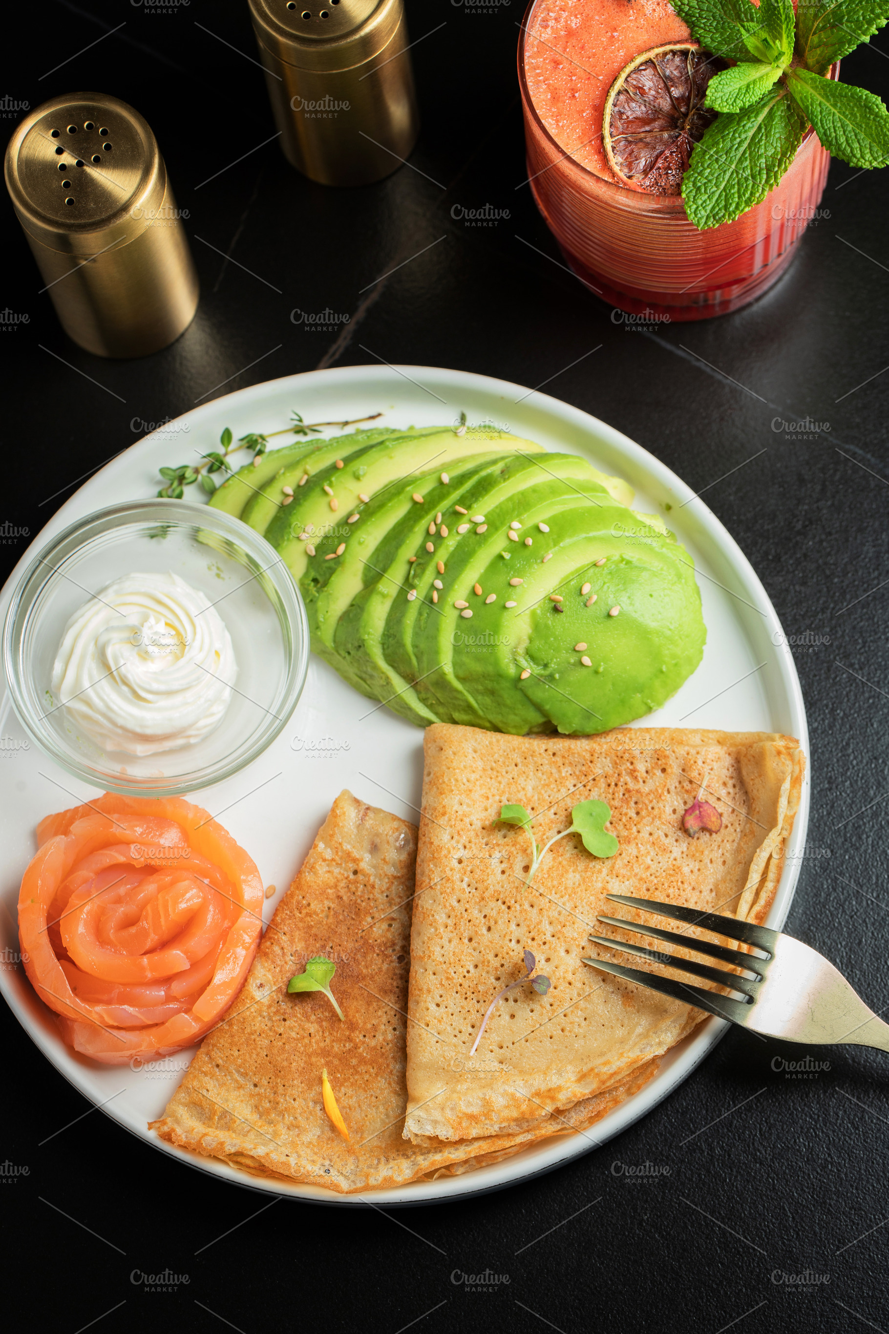 Roasted thin pancakes with smoked salmon and sauce, a Food & Drink Photo by Budarinphoto