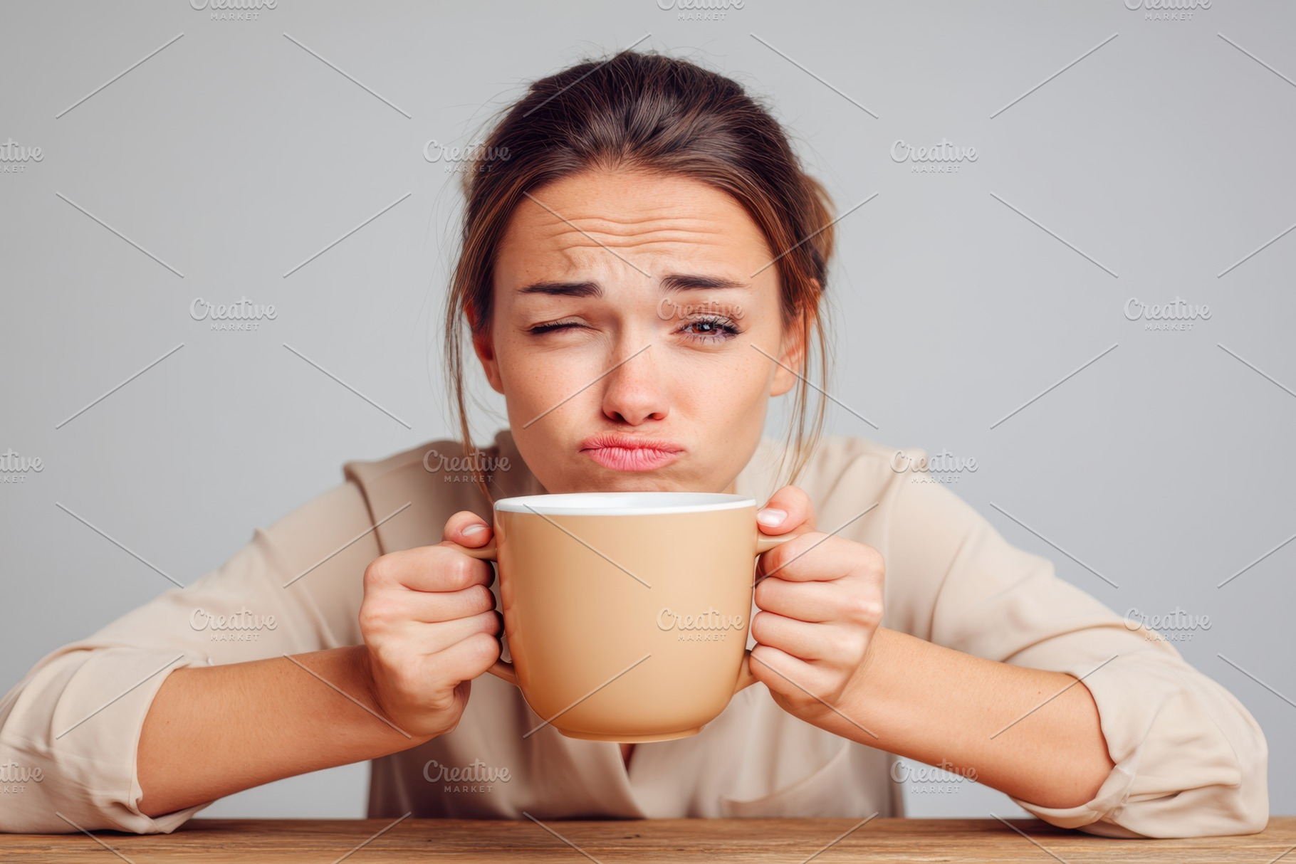 Woman making a funny face with big coffee mug, a Person Photo by AlyaAnd