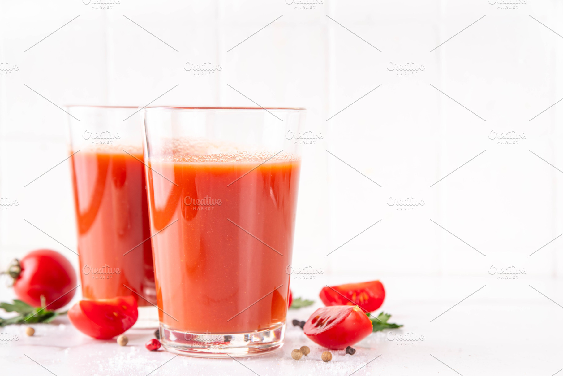 Tasty salted tomato juice in two glasses with fresh ripe tomatoe, a Food & Drink Photo by Rimma