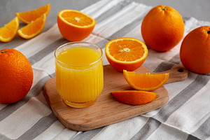 Organic Orange Juice in a Glass, side view., a Food & Drink Photo by LiudmylaChuhunova