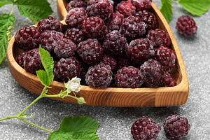 Frozen blackberries in heart shaped wooden bowl, a Food & Drink Photo by Olena Rudo
