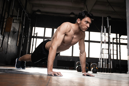 muscular man doing a pushups at gym, a Sports & Recreation Photo by OPOLJA