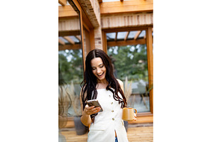 Smiling woman scrolling on, a Person Photo by HalfPoint