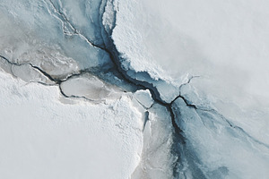 Close-up of a frozen ice surface with cracks, a Background Photo by AlyaAnd