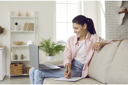 Happy young woman with laptop writes, a Person Photo by StudioRomantic