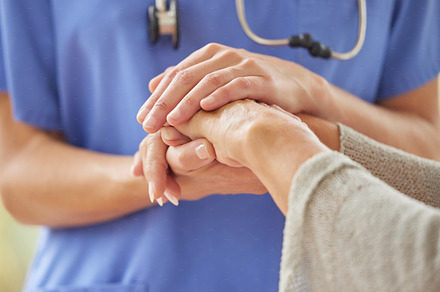 Closeup of caring nurse comforting senior patient in old age home. Zoomed in unknown elderly woman being supported, touching and holding a medical aid's hand. Elderly woman bonding with her caregiver, a Photo by Peopleimages.com