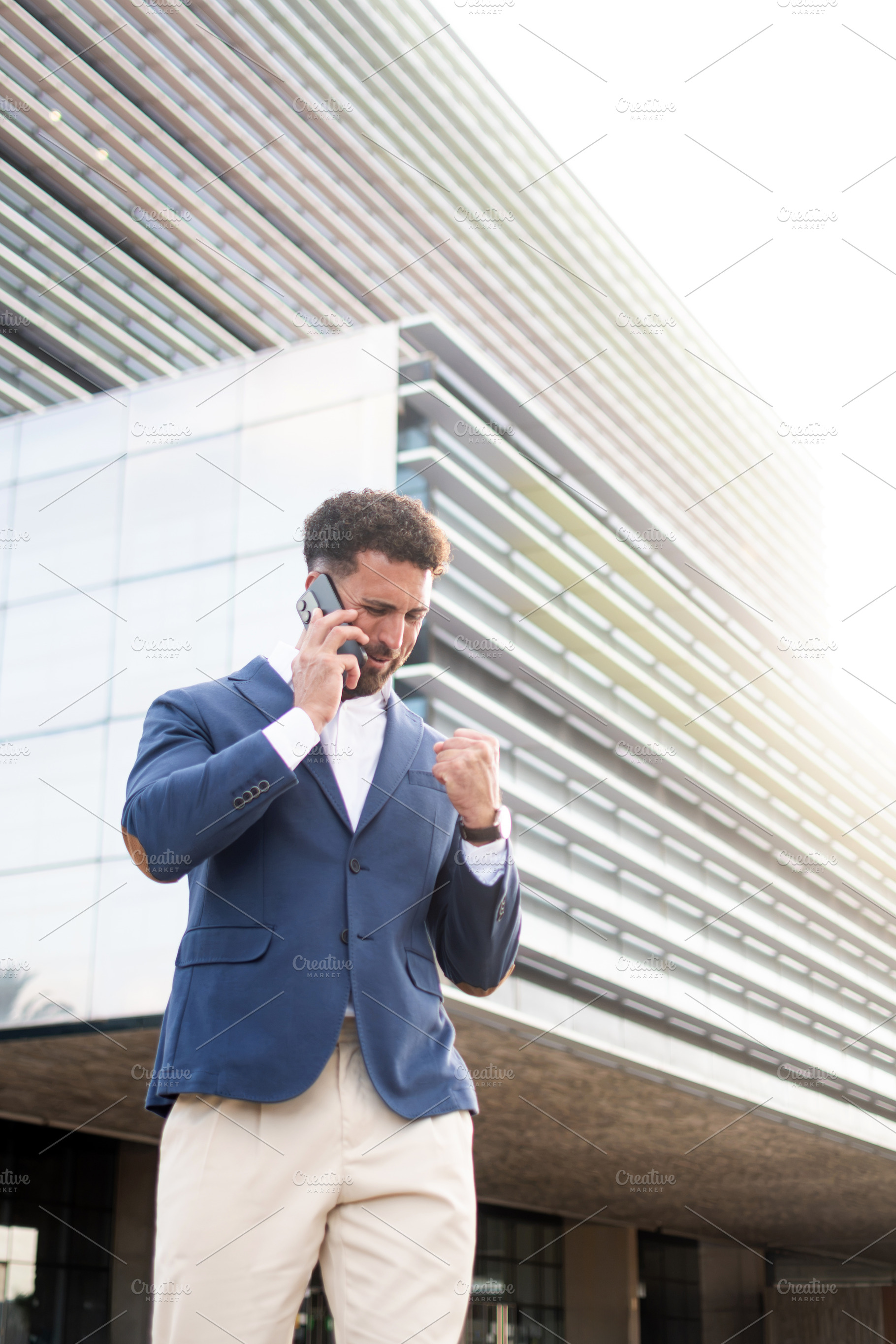 Successful businessman celebrating good news during a phone call, a Business Photo by etorres69