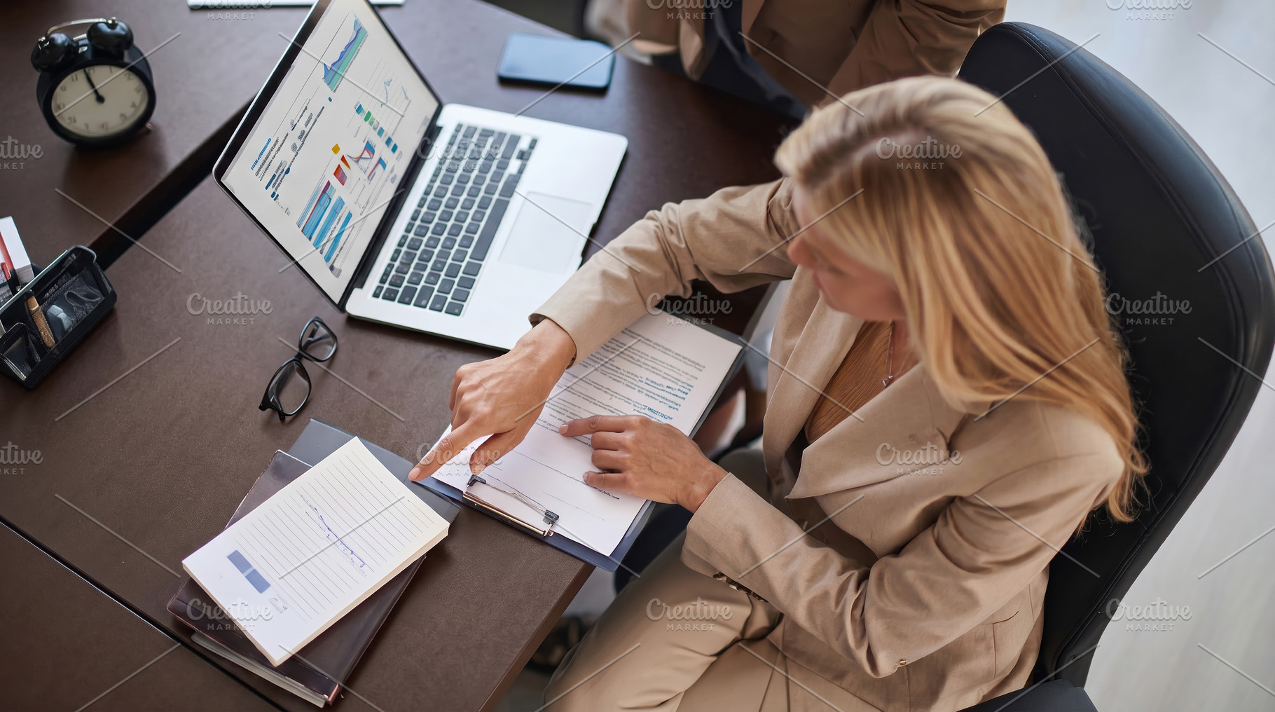 Businesswoman Reviewing Financial Reports at Office Desk, a Business Photo by Davizro's Market
