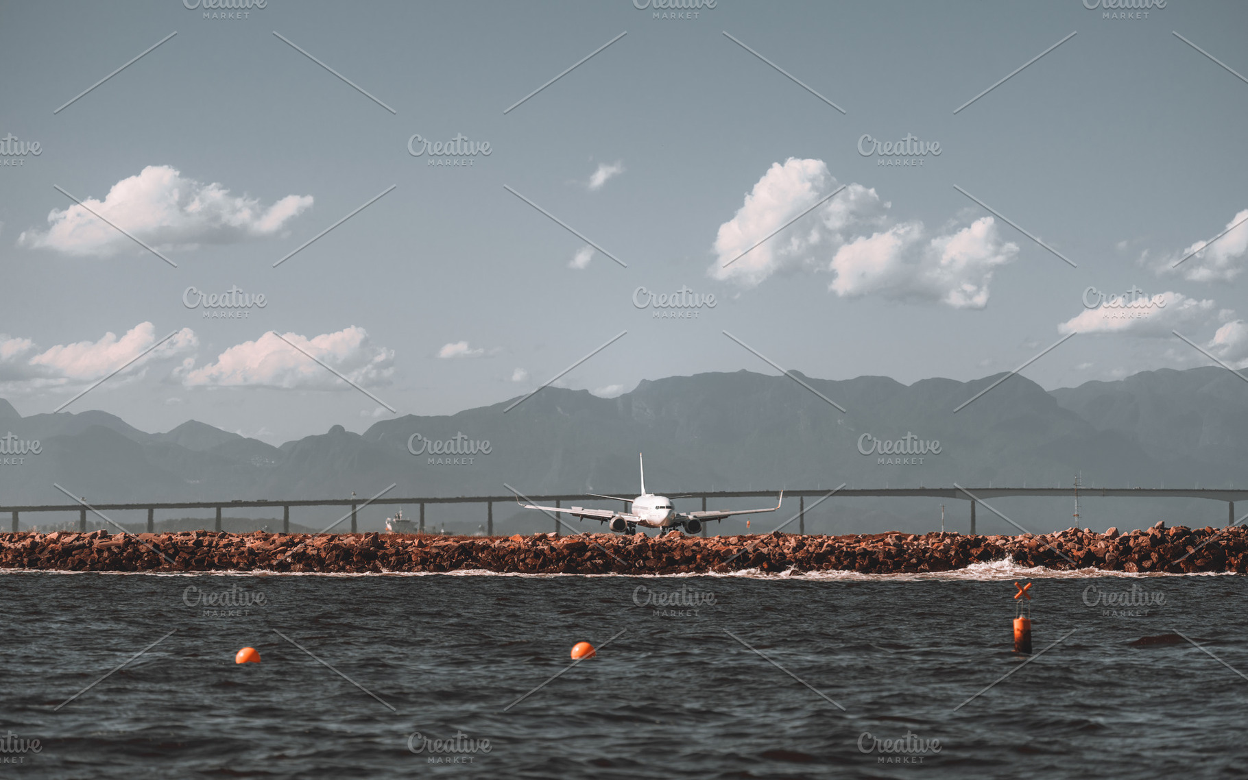 Airplane near sea and mountains, an Industrial Photo by SkyNext