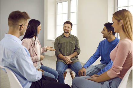 Diverse people sit in circle have, a Person Photo by StudioRomantic