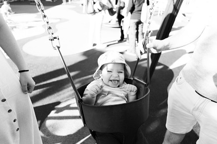 Portrait of a nine month old baby having fun on a swing
