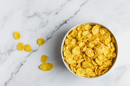 Corn flakes in a bowl on a marble