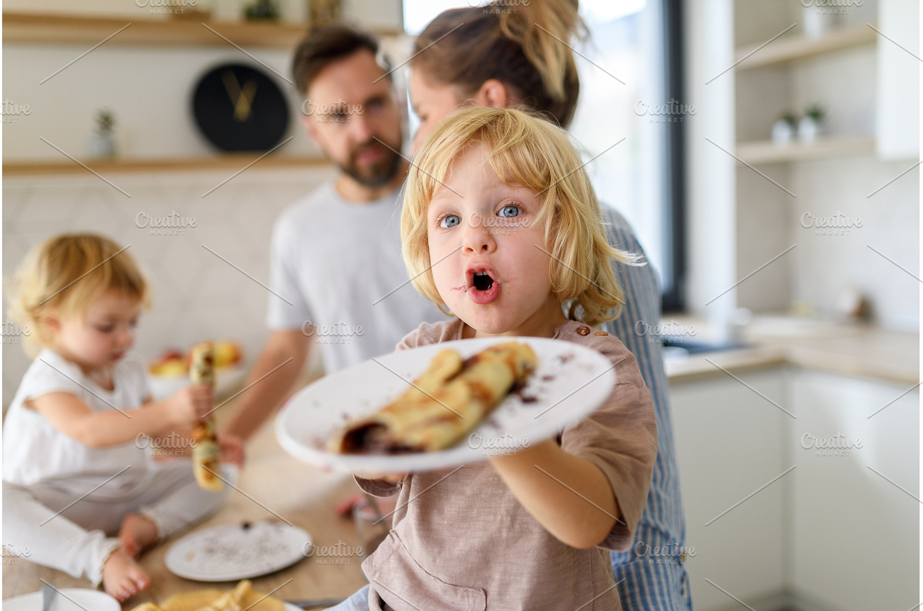 Young nuclear family making pancakes, a Person Photo by HalfPoint
