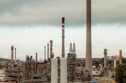 Oil refinery with tall chimneys, an Industrial Photo by SkyNext