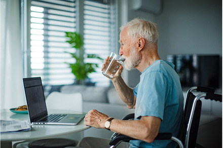 Senior man in a wheelchair working, a Technology Photo by HalfPoint