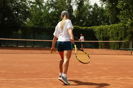 Two people playing tennis on clay court, a Sports & Recreation Photo by AtlasStudio PRO