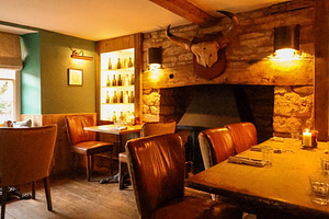 Warm light illuminating a rustic cozy restaurant interior with s, a Photo by Studio ANNA