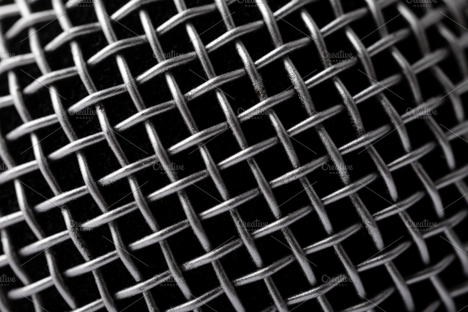 Detailed macro shot of a metallic microphone grill, showing inte, a Holiday Photo by Ales Munt