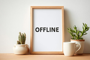 Wall poster displaying offline message with plants and a mug on a wooden table, a Background Photo by AlyaAnd
