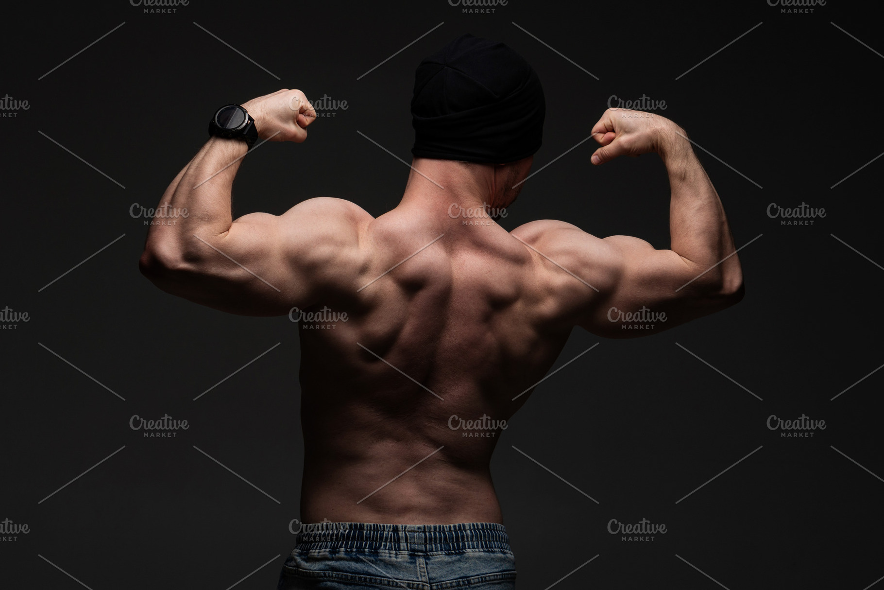 Shirtless man flexing back muscles, a Sports & Recreation Photo by Elena Vagengeim