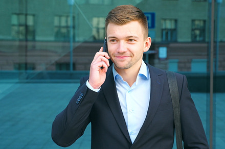 Young businessman talking on phone featuring phone, conversation, and talk