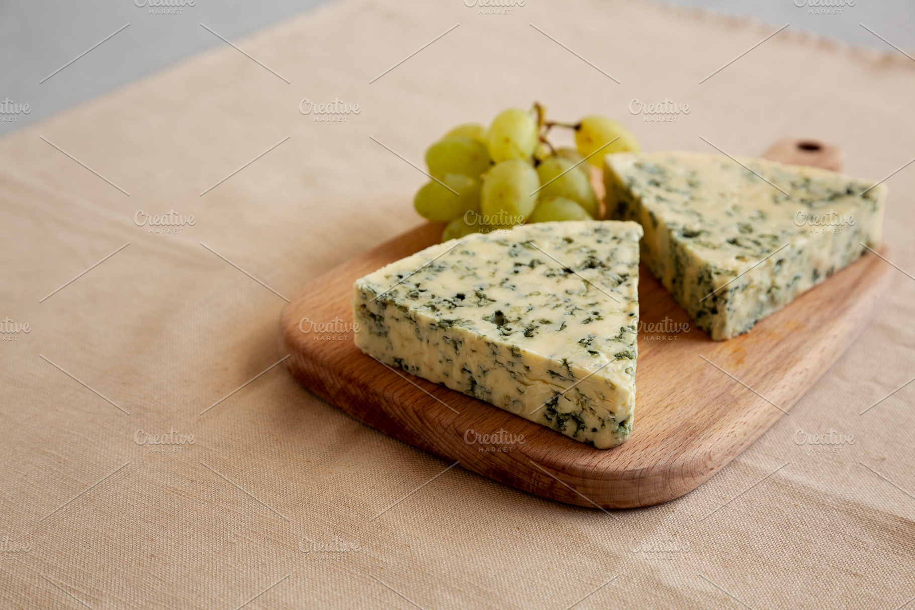 Delicious Cheese Danablu on a wooden board, side view. Copy spac, a Food & Drink Photo by LiudmylaChuhunova