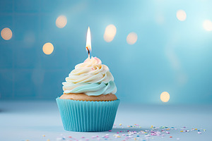 Birthday cupcake with candle on blue, a Photo by Iftikhar Alam