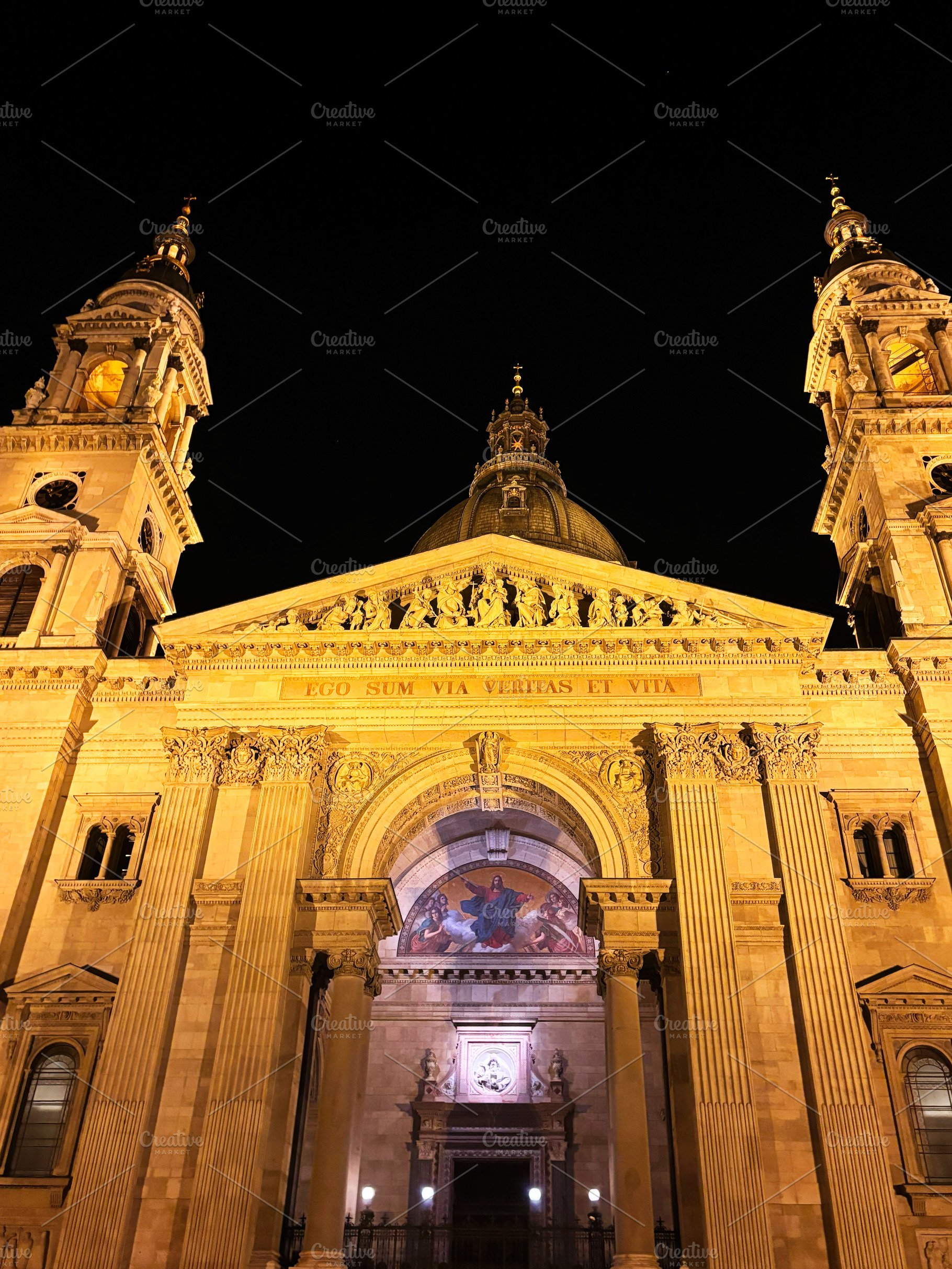 Illuminated facade of historic cathedral at night showcasing architecture. St., a Photo by AS photostudio