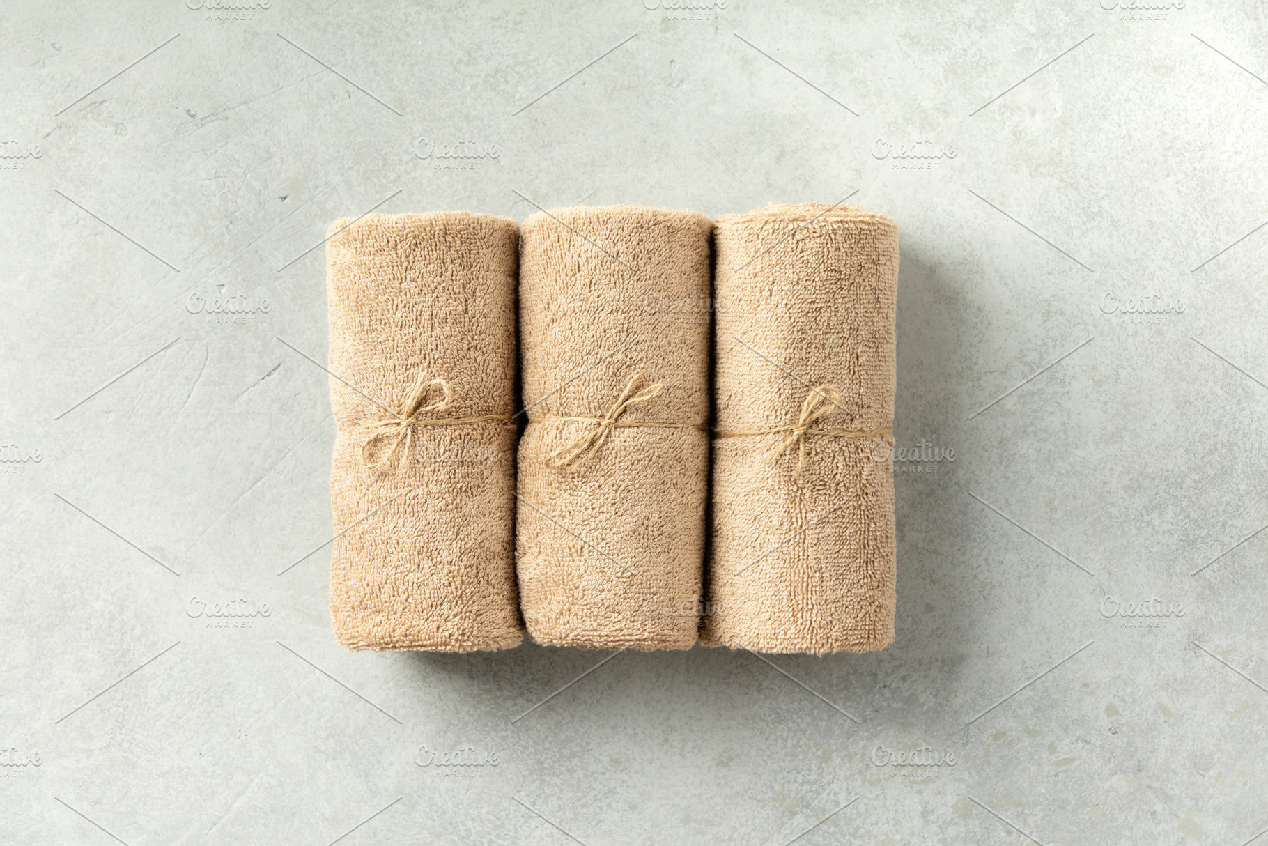 Minimalist Rolled Towels on Light Neutral Stone Background, a Beauty & Fashion Photo by Natalia Klenova's Shop