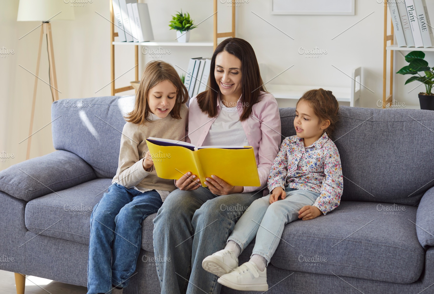 Mother and Kids Reading a Book, a Person Photo by StudioRomantic