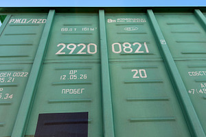 A close-up view of a green shipping container with various markings and numbers, an Industrial Photo by Textures & Backgrounds