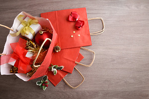 Concept of buying Christmas gifts and decorations with red bags, a Holiday Photo by Davizro's Market